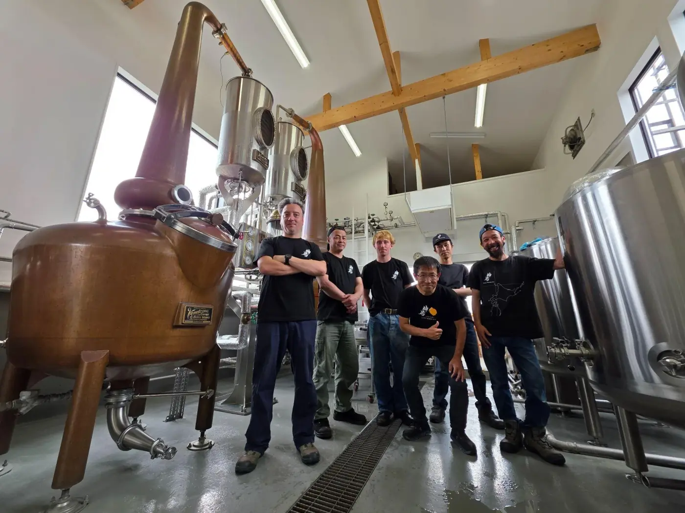 Head Distiller Javier Negrete and the Kamui Whisky team standing beside the copper pot still at the Rishiri Distillery